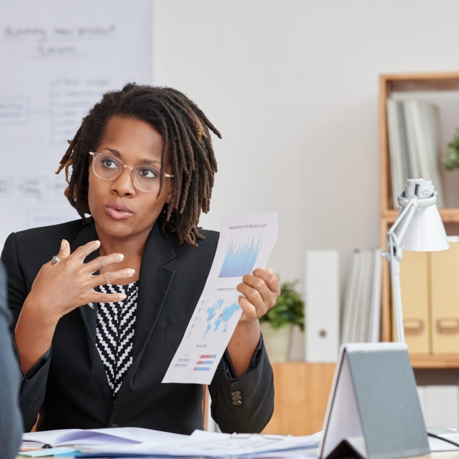 African-American business woman explaining results of her work to colleague